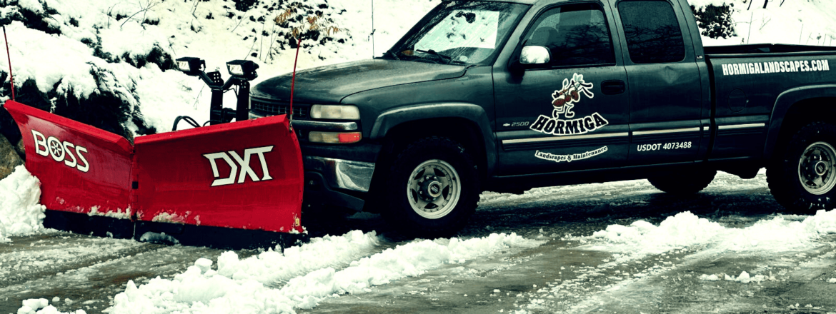 Professional snow removal service in Salt Lake City by Hormiga Landscapes clearing a residential driveway after a heavy snowfall.