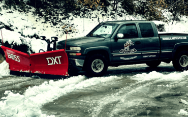 Professional snow removal service in Salt Lake City by Hormiga Landscapes clearing a residential driveway after a heavy snowfall.