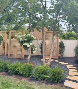 Landscaped garden with trees, shrubs, and colorful flowers