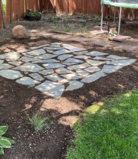 Modern outdoor patio with stone and seating area
